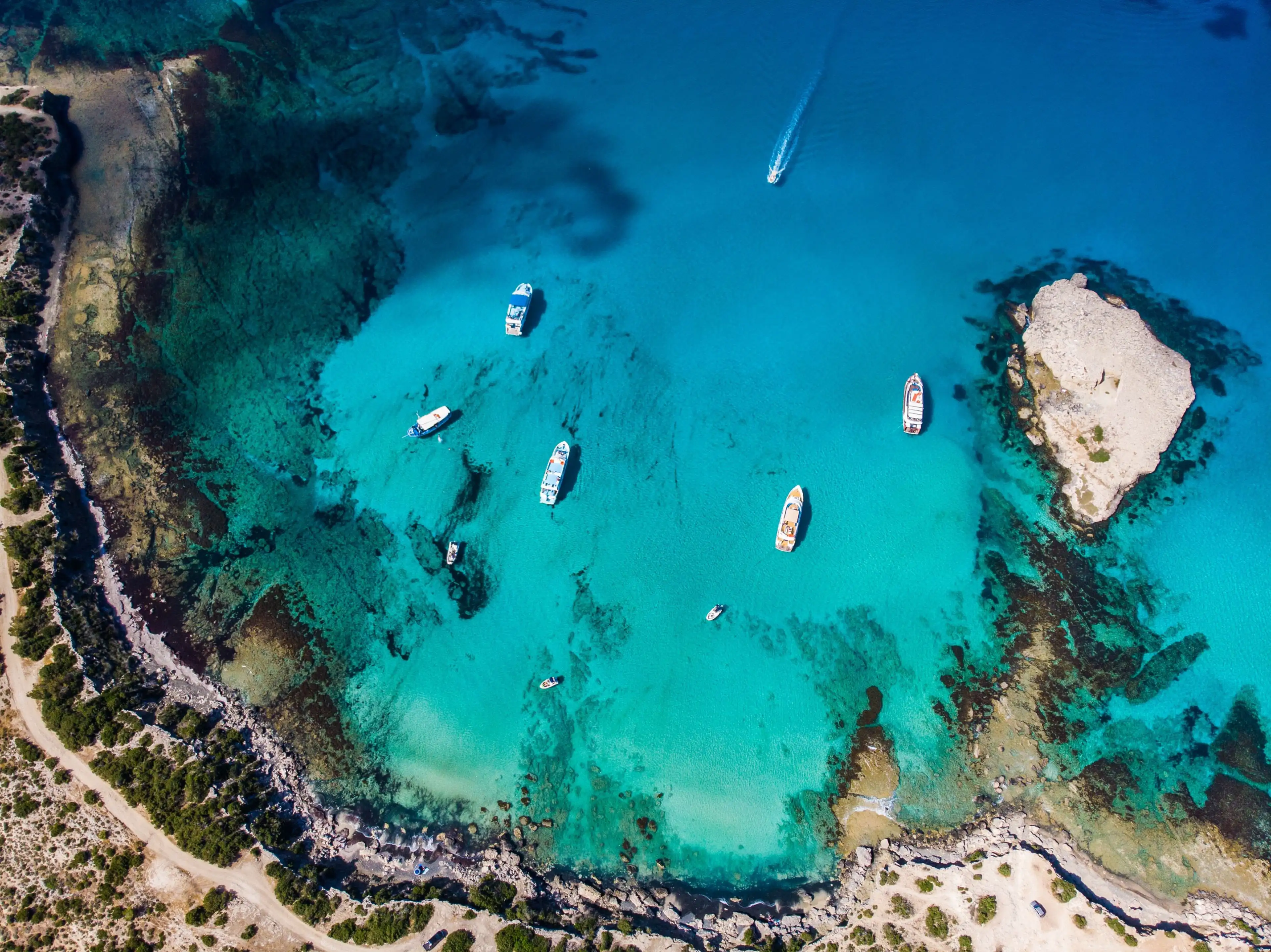 Aerial view of the Blue Lagoon at Akamas Peninsula, Cyprus, with turquoise water and rugged coastline